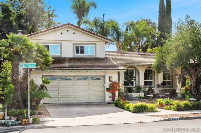 a front view of house with yard outdoor seating and trees