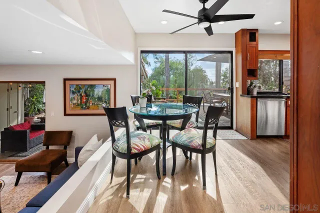 a dining room with furniture a window and wooden floor