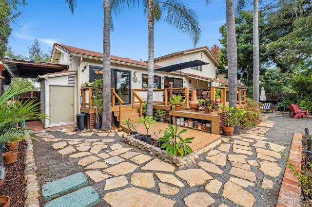 a view of a house with backyard and sitting area