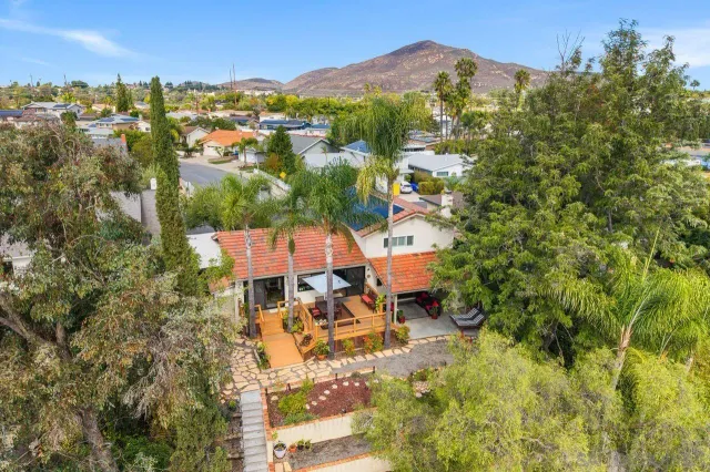 an aerial view of a house with a yard