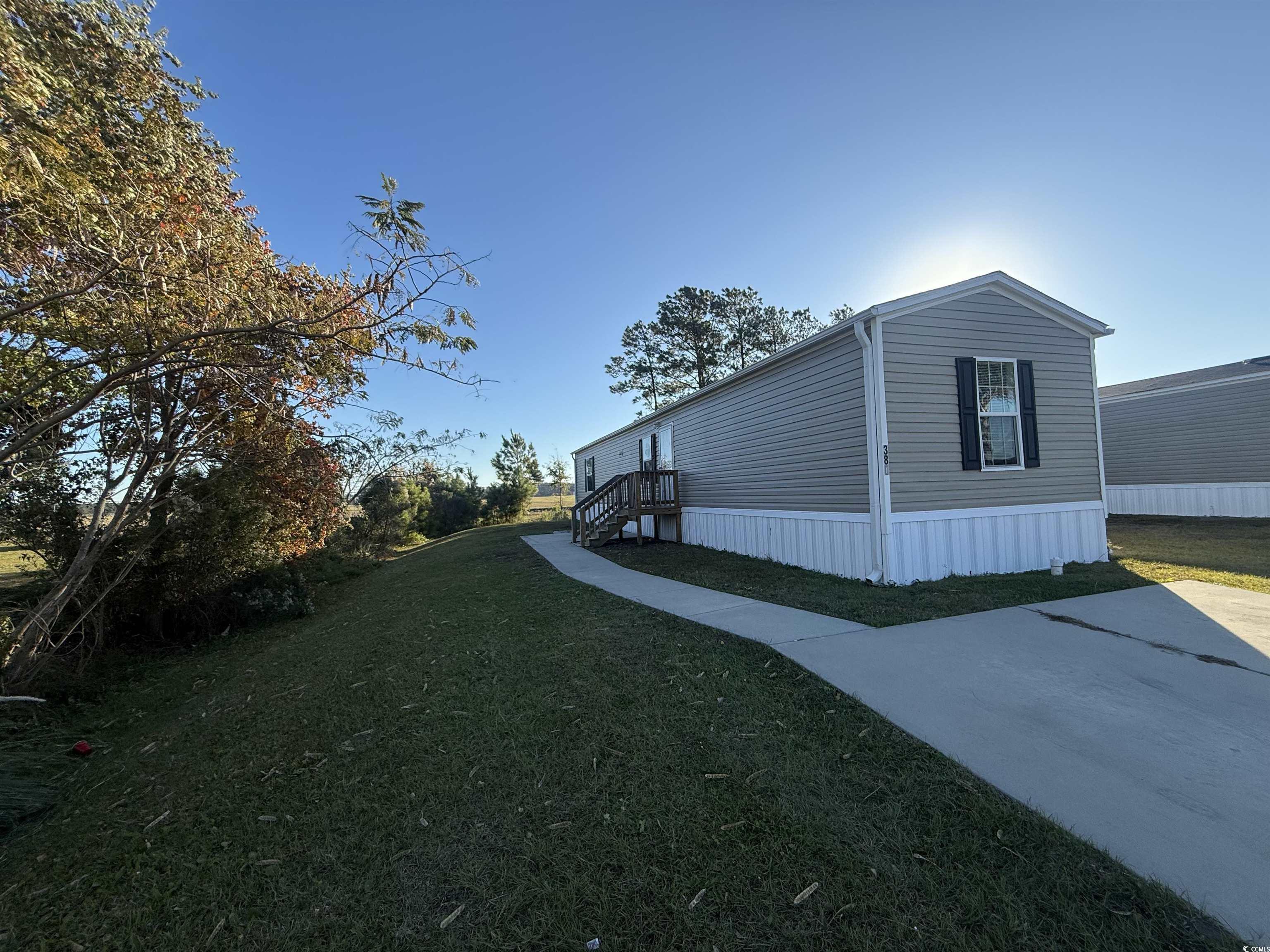 380 Hangar Court Myrtle Beach, SC 29577 - Photo 2 of 16 View of property exterior featuring a lawn