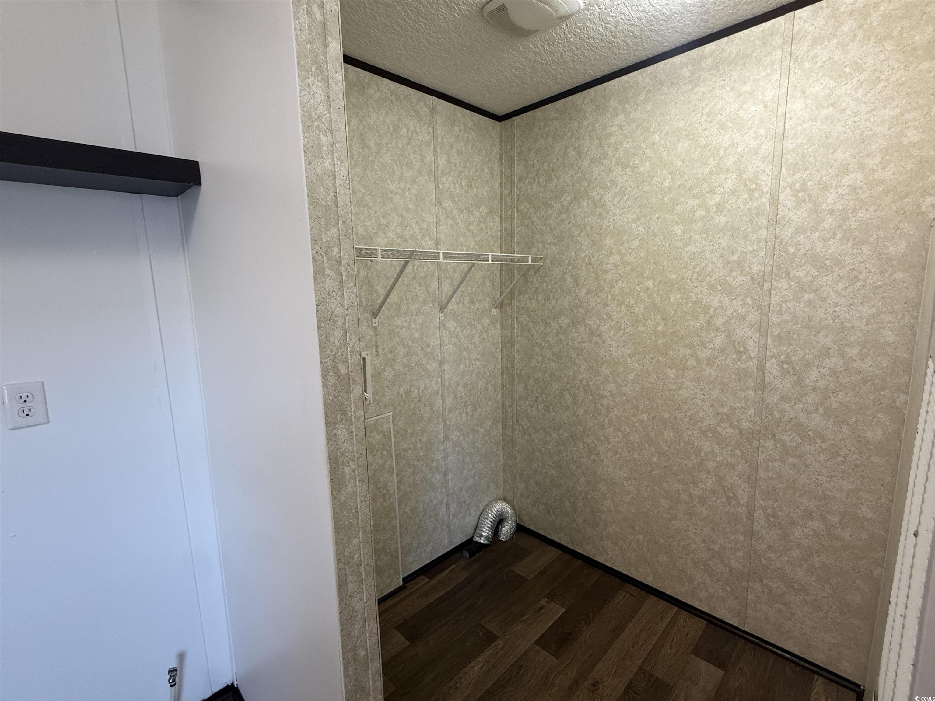 380 Hangar Court Myrtle Beach, SC 29577 - Photo 8 of 16 Washroom with dark wood finished floors and a textured ceiling