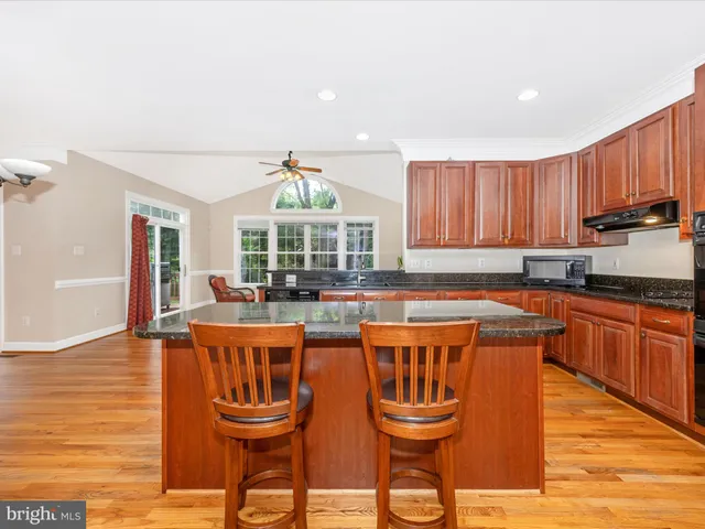 a kitchen with stainless steel appliances granite countertop a stove and a refrigerator