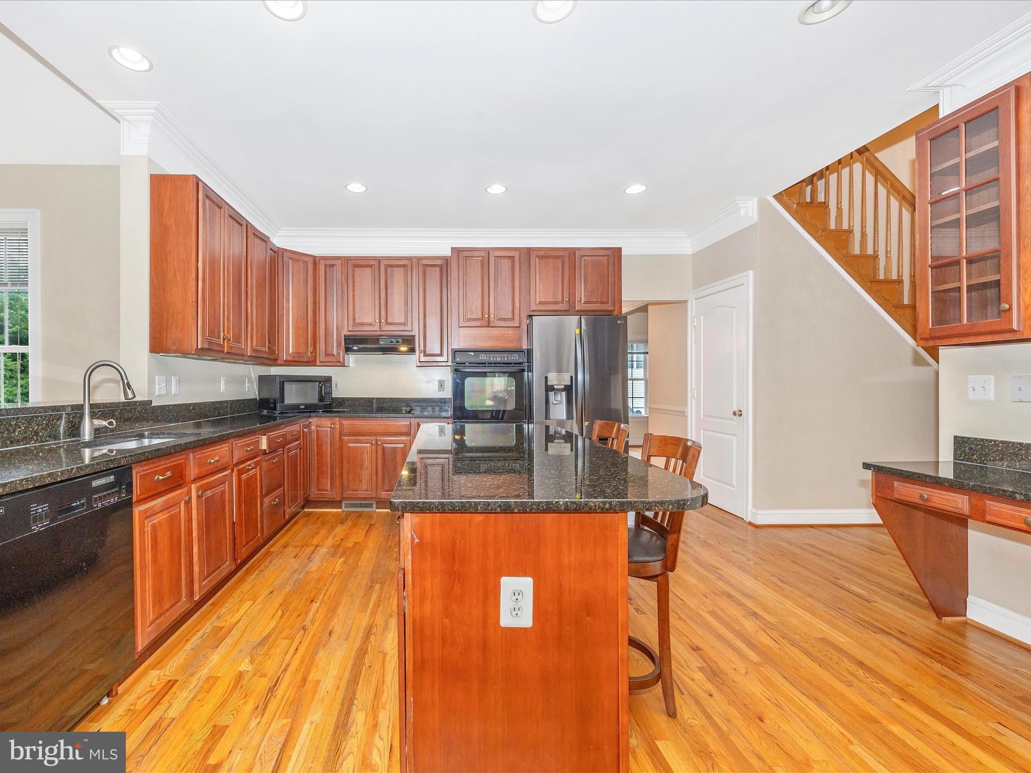 18818 Liberty Mill Road Germantown, MD 20874 - Photo 15 of 39 a view of a kitchen with kitchen island granite countertop wooden floors granite counter tops and a sink