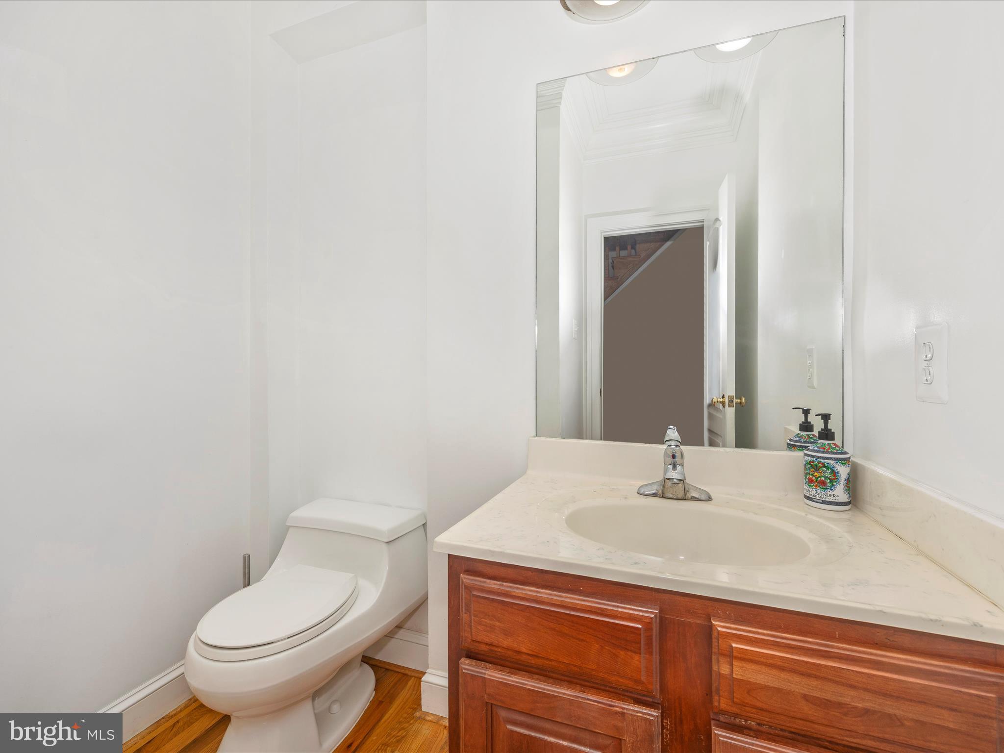 18818 Liberty Mill Road Germantown, MD 20874 - Photo 17 of 39 a bathroom with a sink a toilet and mirror