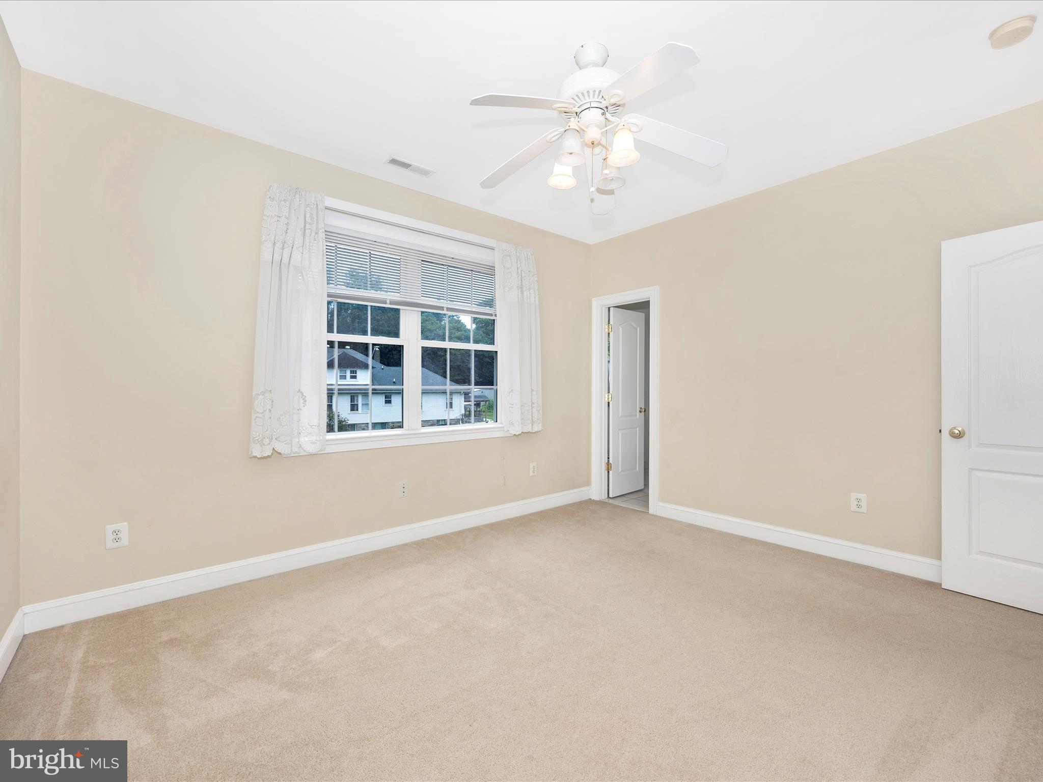 18818 Liberty Mill Road Germantown, MD 20874 - Photo 25 of 39 an empty room with windows and chandelier fan
