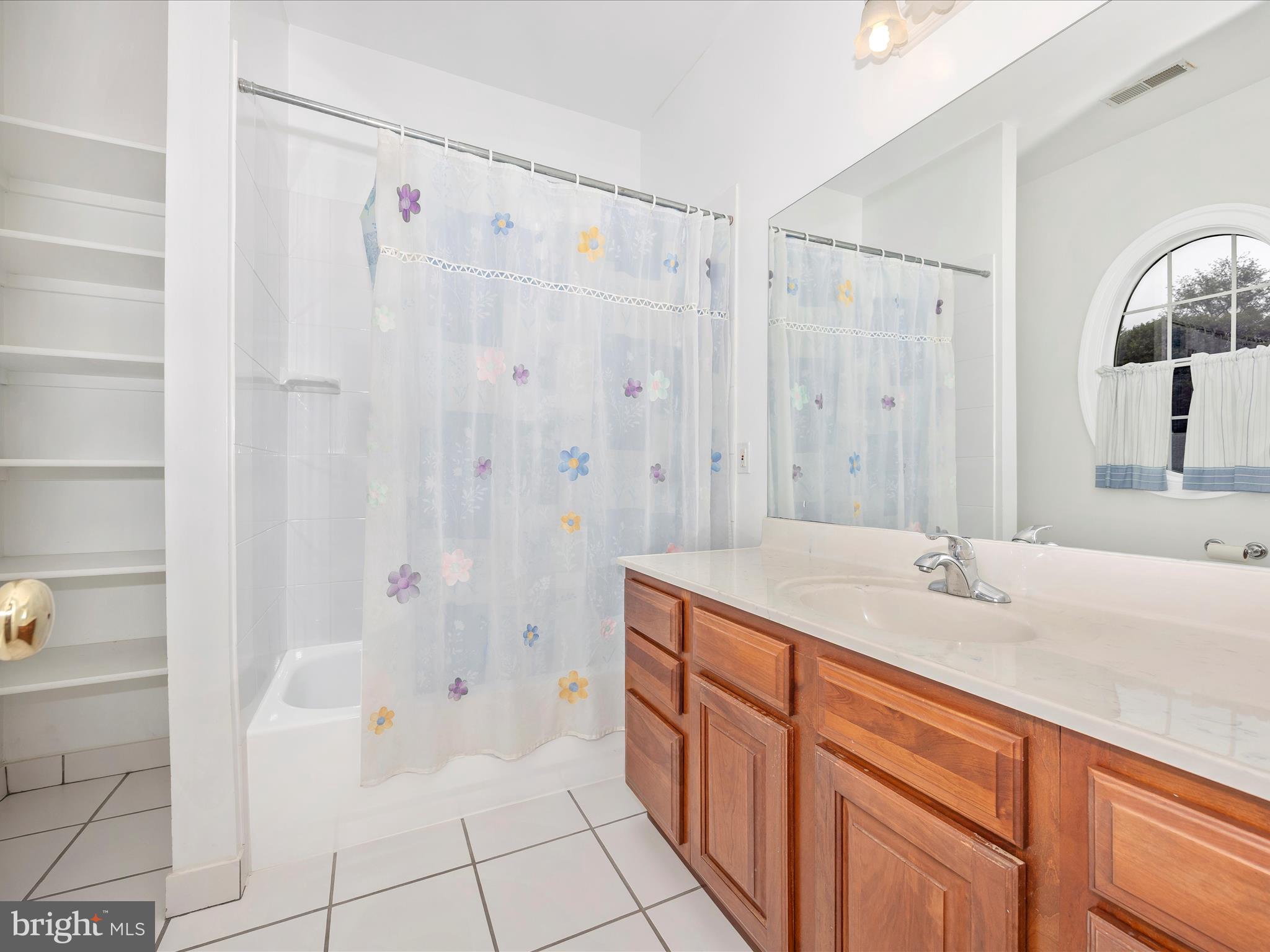 18818 Liberty Mill Road Germantown, MD 20874 - Photo 26 of 39 a bath room with a sink and a mirror