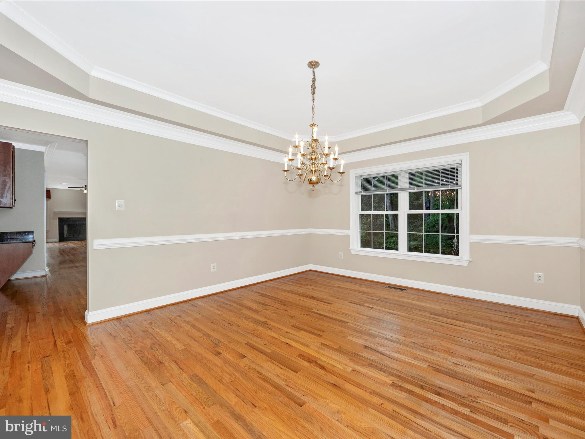18818 Liberty Mill Road Germantown, MD 20874 - Photo 7 of 39 a view of an empty room with wooden floor and a window