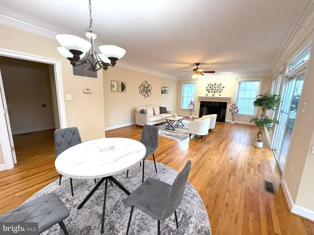 a living room with fireplace furniture and a wooden floor