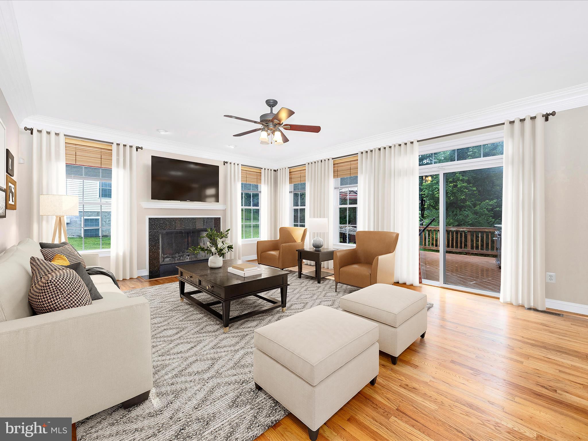 18818 Liberty Mill Road Germantown, MD 20874 - Photo 9 of 39 a living room with furniture a fireplace and a flat screen tv