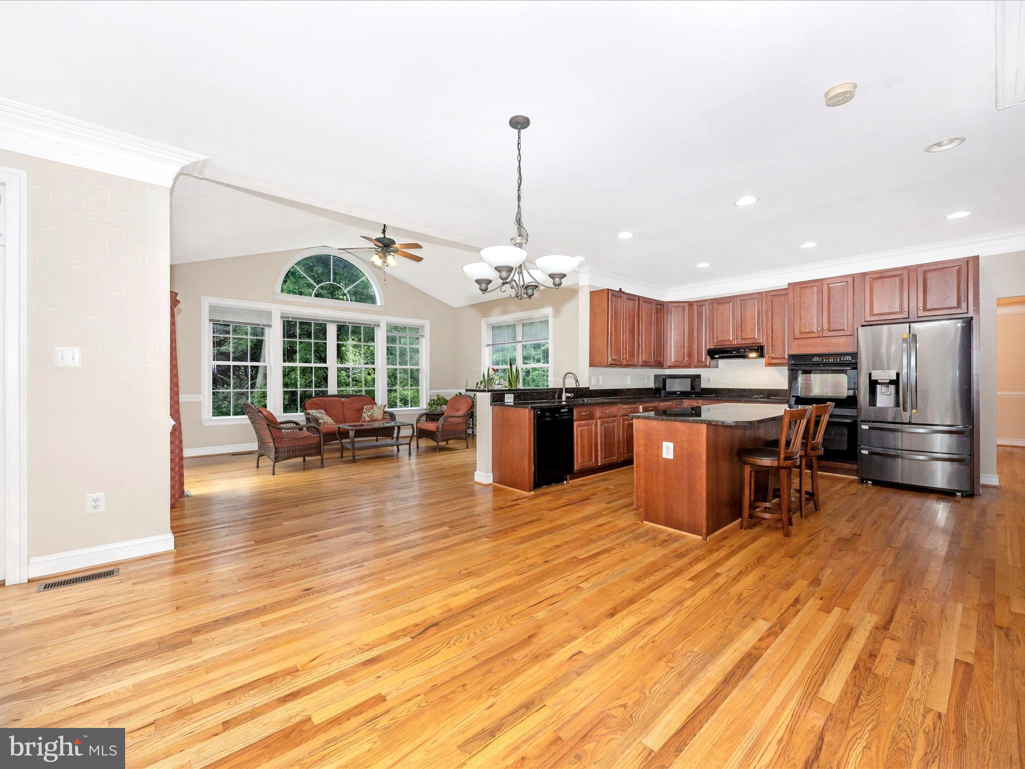 18818 Liberty Mill Road Germantown, MD 20874 - Photo 10 of 39 a open kitchen view with stainless steel appliances granite countertop a stove and a wooden floors