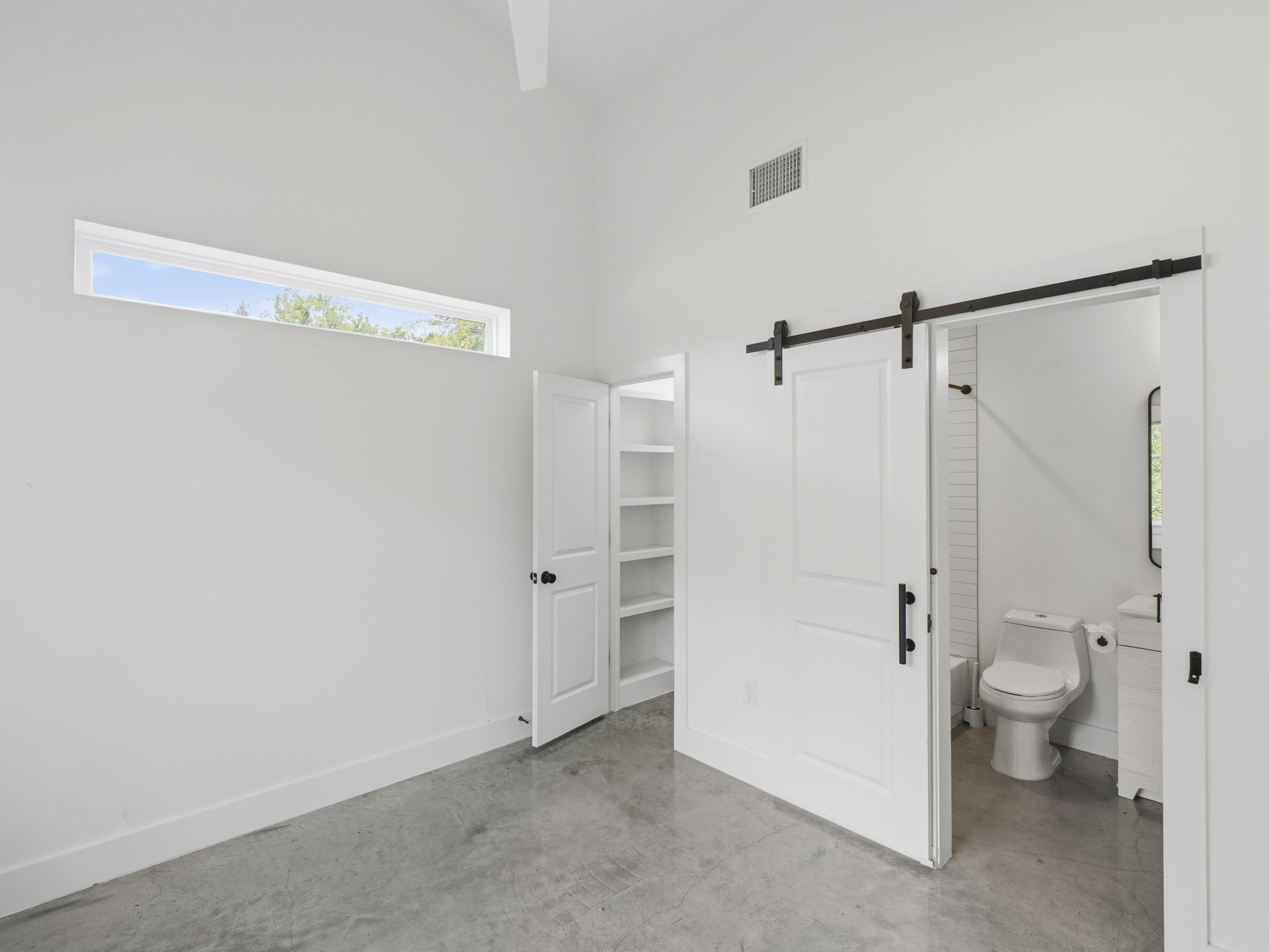 5005 Lott Avenue, Unit 2 Austin, TX 78721 - Photo 10 of 25 Minimalist design and high ceilings create an open, airy atmosphere in this inviting bedroom.