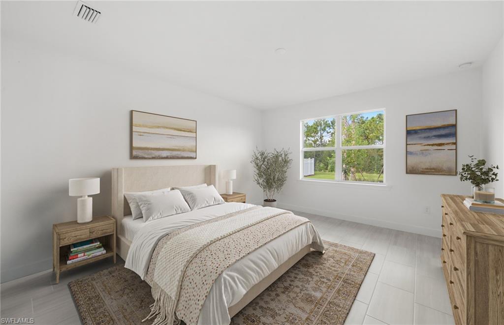 15779 Northridge Road Punta Gorda, FL 33982 - Photo 11 of 24 a bedroom with a bed a mirror and a window