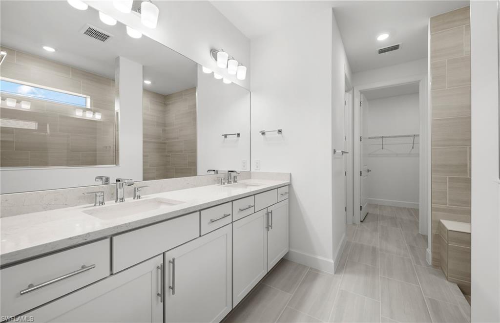 15779 Northridge Road Punta Gorda, FL 33982 - Photo 12 of 24 a bathroom with a double vanity sink mirror and shower