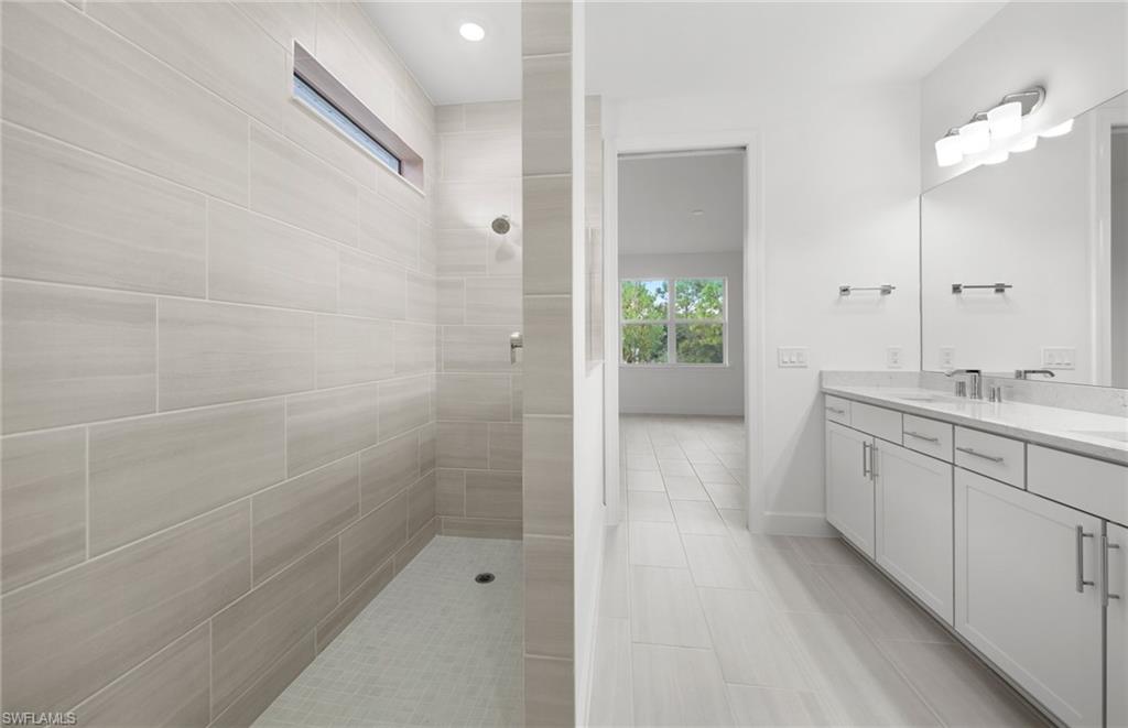 15779 Northridge Road Punta Gorda, FL 33982 - Photo 13 of 24 a bathroom with a granite countertop sink a shower and a mirror