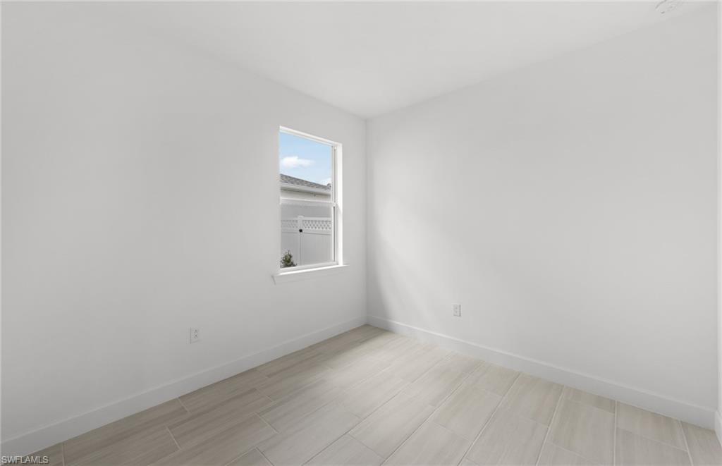 15779 Northridge Road Punta Gorda, FL 33982 - Photo 16 of 24 a view of a small space with wooden floor and a window