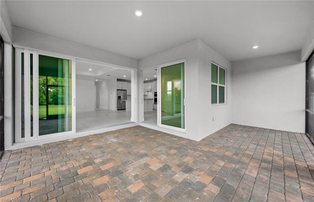 15779 Northridge Road Punta Gorda, FL 33982 - Photo 20 of 24 a view of an empty room with glass door and windows