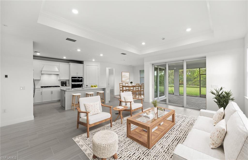 15779 Northridge Road Punta Gorda, FL 33982 - Photo 2 of 24 a living room with furniture and a large window with kitchen view