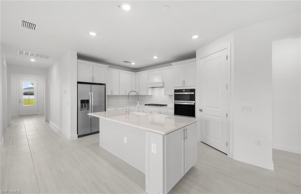 15779 Northridge Road Punta Gorda, FL 33982 - Photo 4 of 24 a kitchen with refrigerator and cabinets