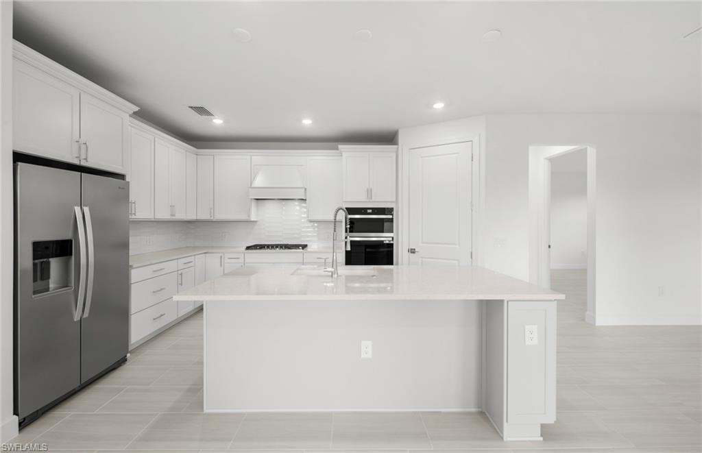 15779 Northridge Road Punta Gorda, FL 33982 - Photo 5 of 24 a large kitchen with stainless steel appliances double sink and cabinets