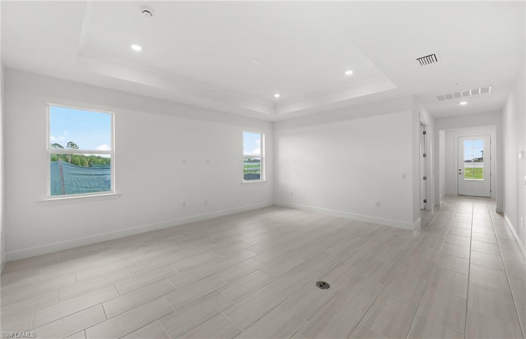 15779 Northridge Road Punta Gorda, FL 33982 - Photo 7 of 24 an empty room with wooden floor and windows