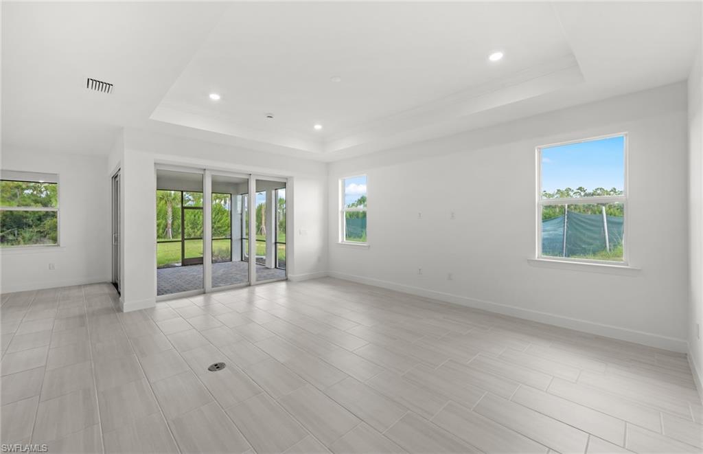 15779 Northridge Road Punta Gorda, FL 33982 - Photo 8 of 24 an empty room with wooden floor and windows