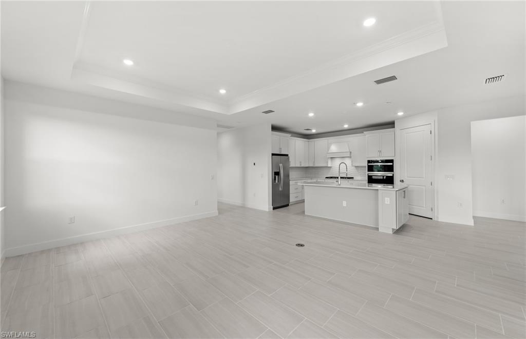 15779 Northridge Road Punta Gorda, FL 33982 - Photo 9 of 24 a view of kitchen with white cabinets and stainless steel appliances