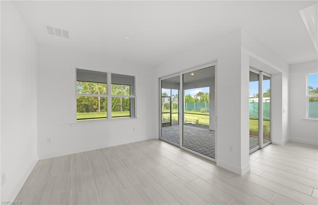 15779 Northridge Road Punta Gorda, FL 33982 - Photo 10 of 24 an empty room with wooden floor and windows