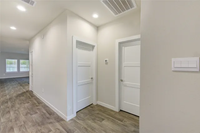 an empty room with wooden floor