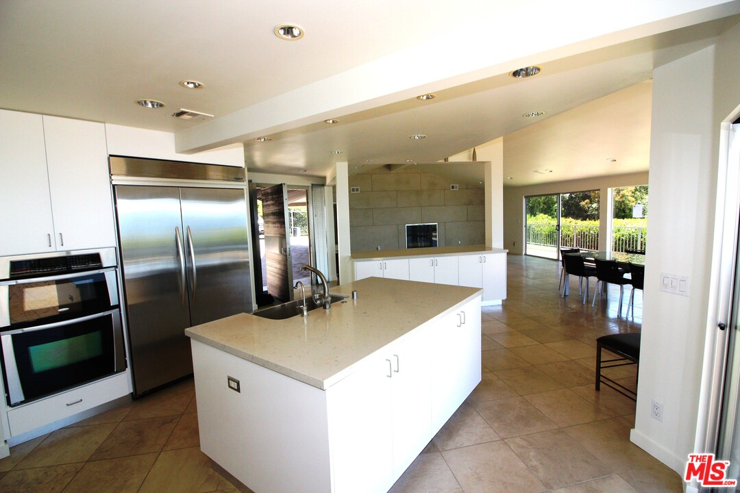 20534 Roca Chica Drive Malibu, CA 90265 - Photo 2 of 38 a kitchen with stainless steel appliances granite countertop a sink and a refrigerator