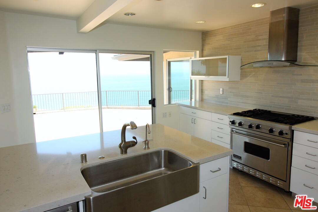 20534 Roca Chica Drive Malibu, CA 90265 - Photo 11 of 38 a kitchen with a stove and a sink