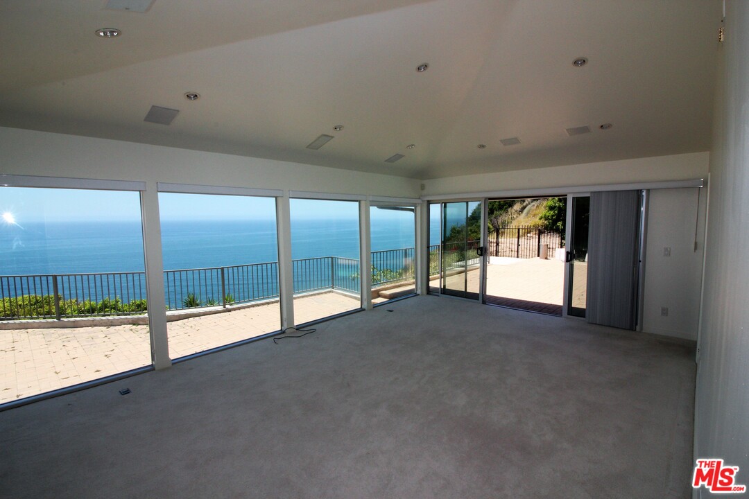 20534 Roca Chica Drive Malibu, CA 90265 - Photo 3 of 38 a view of an empty room with a sliding door