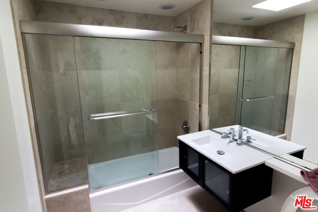 20534 Roca Chica Drive Malibu, CA 90265 - Photo 24 of 38 a bathroom with a sink and shower