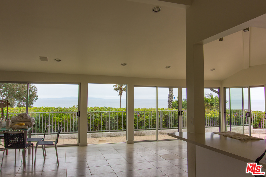 20534 Roca Chica Drive Malibu, CA 90265 - Photo 28 of 38 a view of an empty room with wooden floor and door