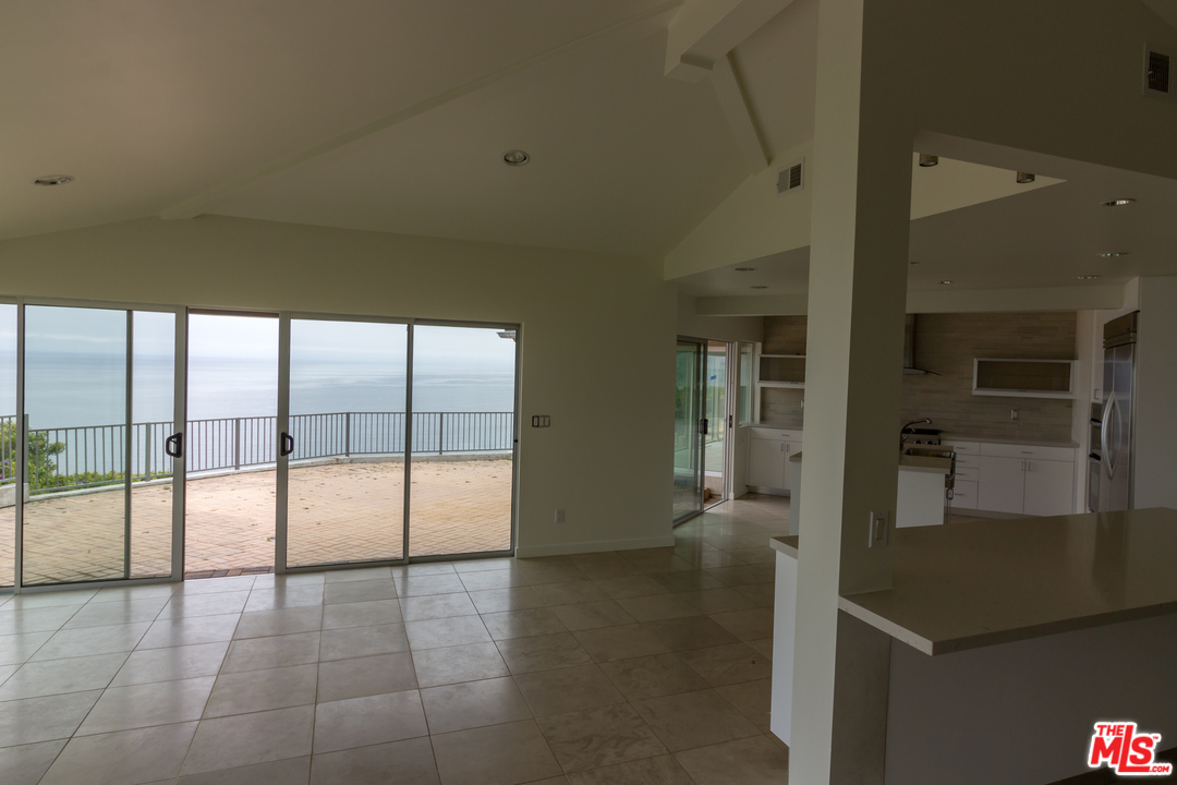 20534 Roca Chica Drive Malibu, CA 90265 - Photo 32 of 38 wooden floor in an empty room with a fireplace