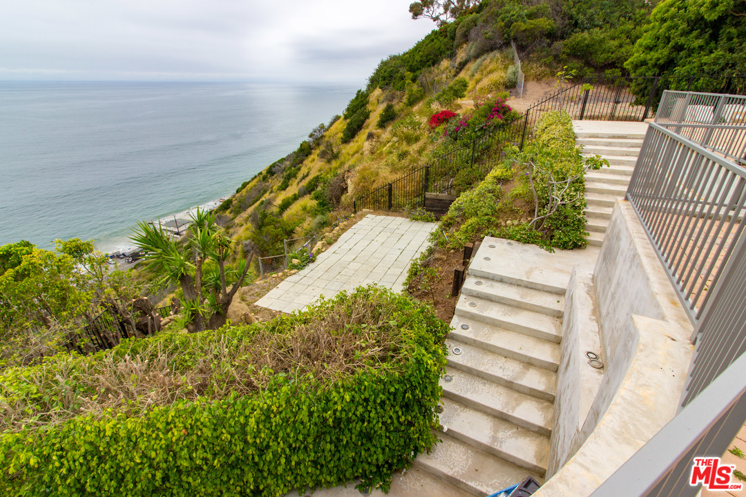 20534 Roca Chica Drive Malibu, CA 90265 - Photo 35 of 38 a view of flower garden with wooden fence