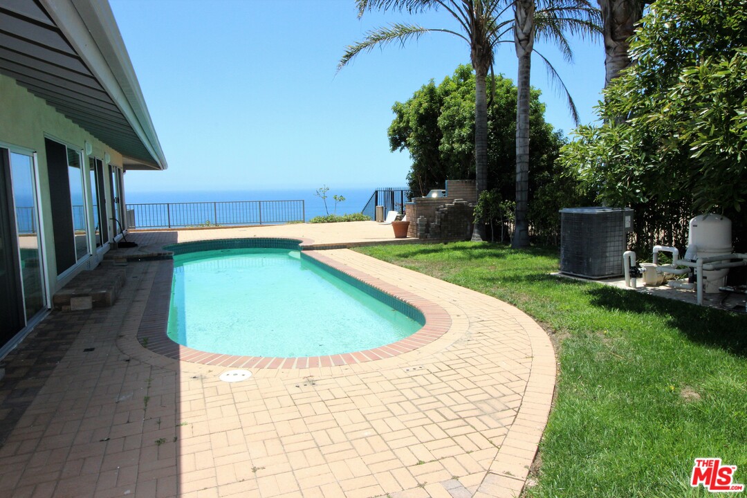 20534 Roca Chica Drive Malibu, CA 90265 - Photo 6 of 38 a view of a swimming pool with a yard