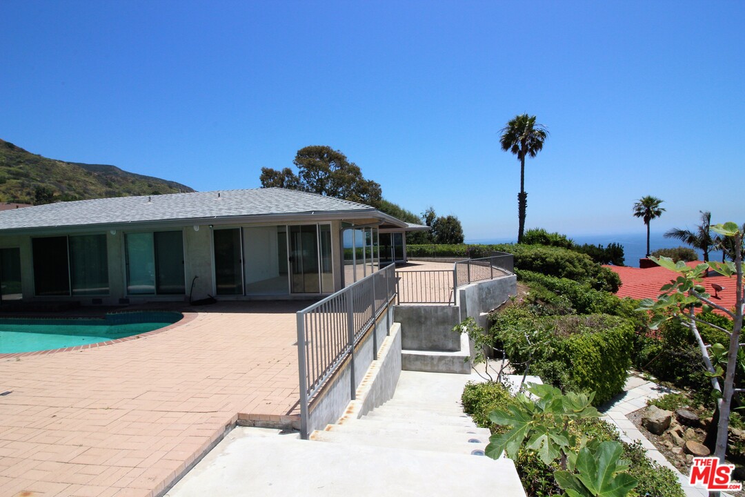 20534 Roca Chica Drive Malibu, CA 90265 - Photo 8 of 38 a front view of a house with a yard