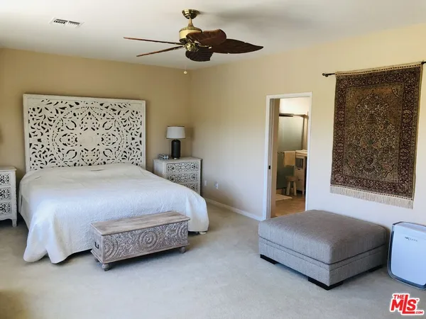 a bedroom with a bed and lamp