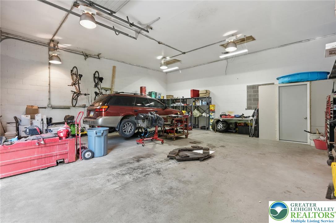 9033 Loop Road Slatington, PA 18080 - Photo 9 of 53 A spacious, multi-purpose garage offers ample room for vehicles, storage, and a dedicated workspace.