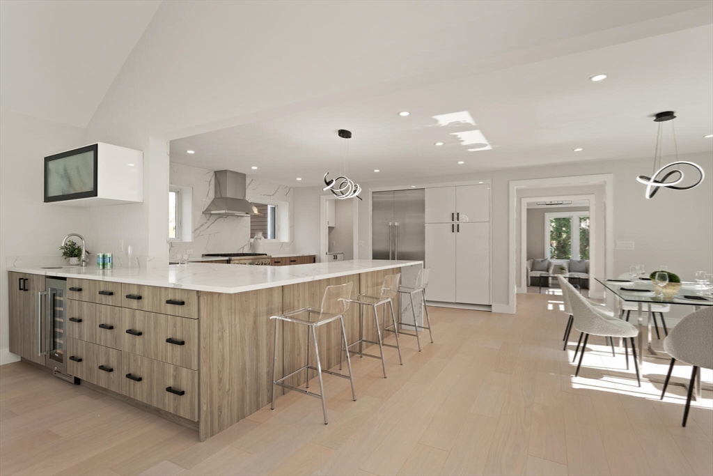 21 Richard Road Lexington, MA 02421 - Photo 12 of 34 a large white kitchen with cabinets chairs and a sink