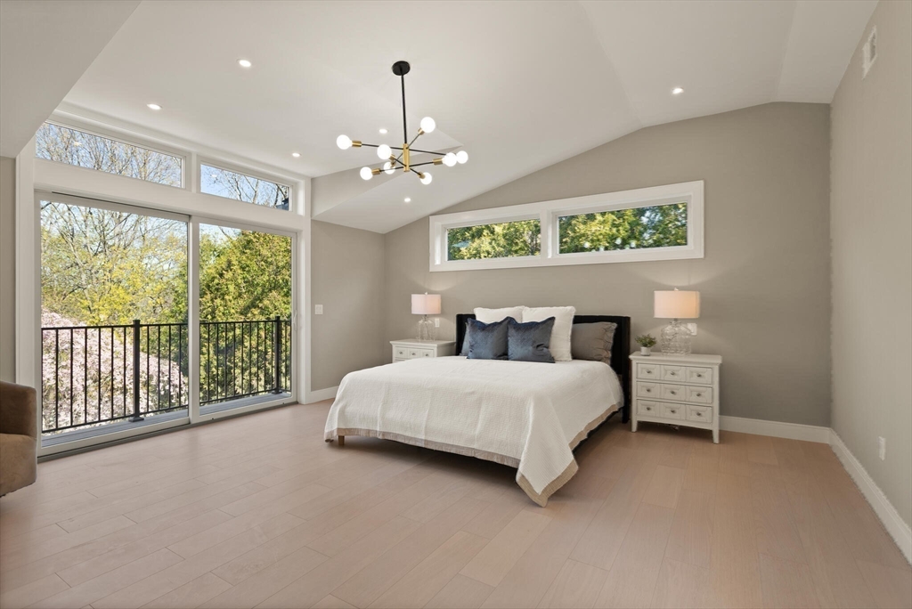 21 Richard Road Lexington, MA 02421 - Photo 20 of 34 a spacious bedroom with a large bed and a chandelier