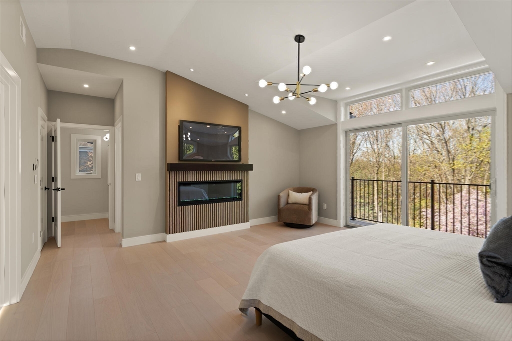 21 Richard Road Lexington, MA 02421 - Photo 21 of 34 a spacious bedroom with a large bed and a tv