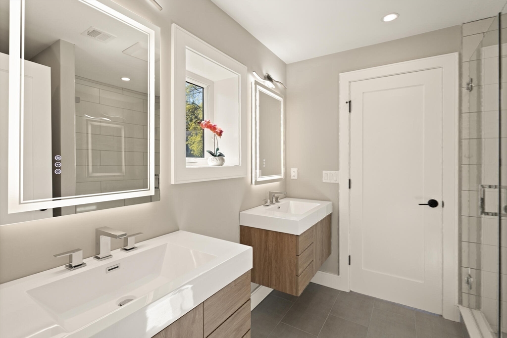 21 Richard Road Lexington, MA 02421 - Photo 26 of 34 a bathroom with a sink double vanity and a mirror