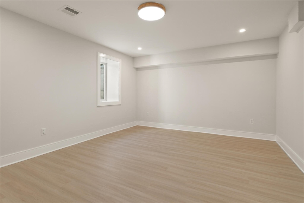 21 Richard Road Lexington, MA 02421 - Photo 29 of 34 wooden floor in an empty room with a window