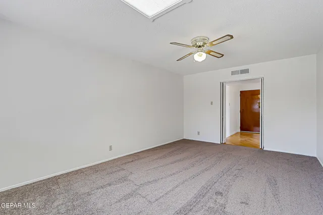 a view of an empty room with a fan