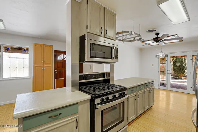 a kitchen with stainless steel appliances a refrigerator and cabinets