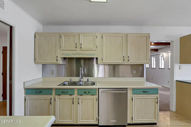 a kitchen with stainless steel appliances a stove refrigerator and microwave