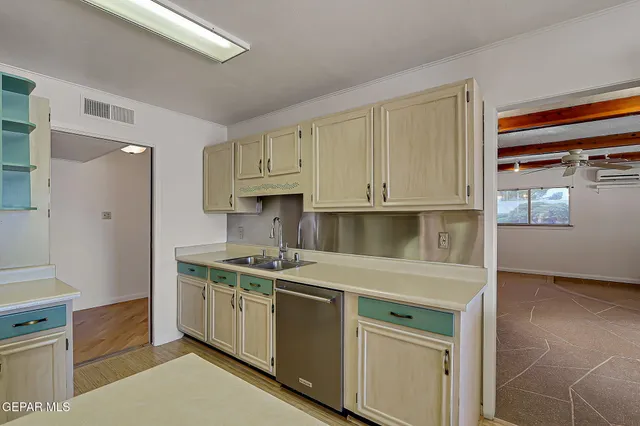 a kitchen with stainless steel appliances granite countertop a refrigerator a stove and a wooden floors