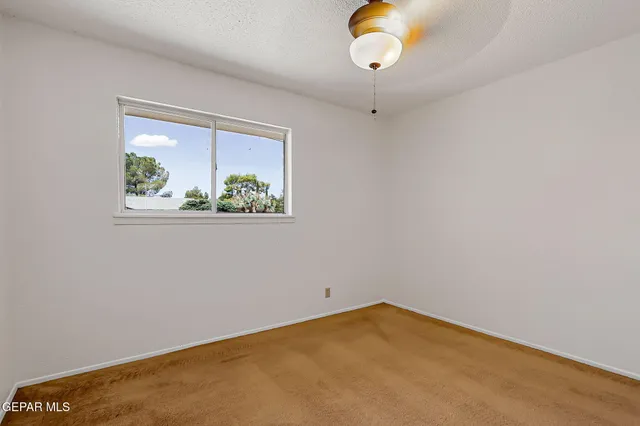 a view of a deck with table and chairs with wooden floor and floor to ceiling window